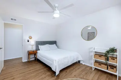 a white bedroom with a bed and a ceiling fan at Echo by Coast to Cactus - Family-Friendly Home in La Mesa