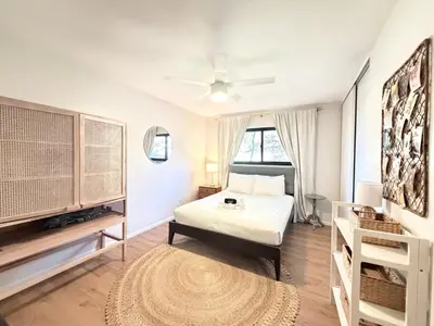 a white bedroom with a bed and a ceiling fan at Echo by Coast to Cactus - Family-Friendly Home in La Mesa