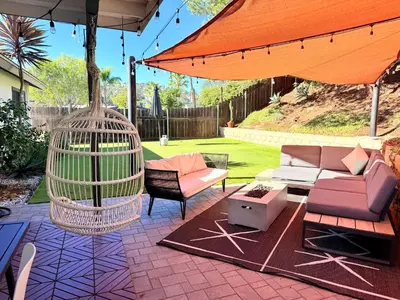 a patio with a bird cage and two chairs at Echo by Coast to Cactus - Family-Friendly Home in La Mesa