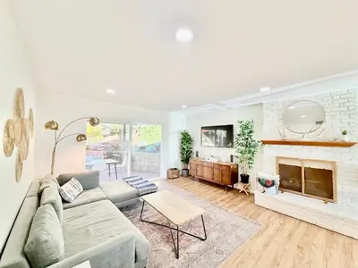 a living room with a couch and a fireplace at Echo by Coast to Cactus - Family-Friendly Home in La Mesa