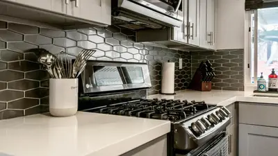a kitchen with a stove and a vase with utensils at San Diego Family Getaway - Spa, Pool, and Patio in San Diego