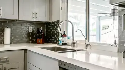 a white kitchen with a sink and a window at San Diego Family Getaway - Spa, Pool, and Patio in San Diego