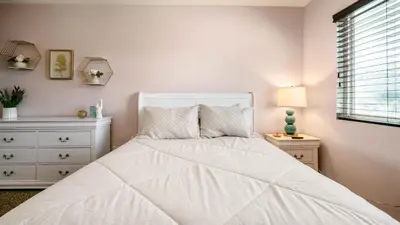 a white bedroom with a white bed and a window at San Diego Family Getaway - Spa, Pool, and Patio in San Diego