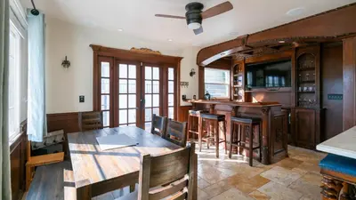 a dining room with a table and a bar at Mediterranean-Style Villa in Point Loma in San Diego