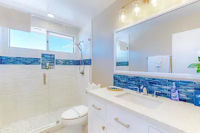 a bathroom with a toilet and a sink and a shower at Bayside Retreat in San Diego