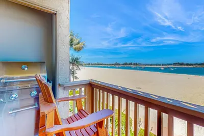a balcony with a stove and a view of the beach at Bayside Retreat in San Diego