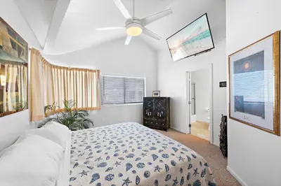 a bedroom with a bed and a ceiling fan at 3 Story Oceanfront Home with Jacuzzi in Newport Beach on the Sand! in Newport Beach