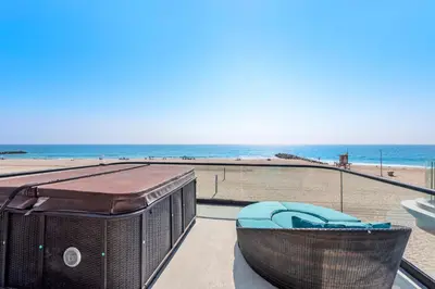 a view of the beach from a balcony at 3 Story Oceanfront Home with Jacuzzi in Newport Beach on the Sand! in Newport Beach