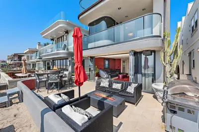 an exterior view of a house with a patio at 3 Story Oceanfront Home with Jacuzzi in Newport Beach on the Sand! in Newport Beach