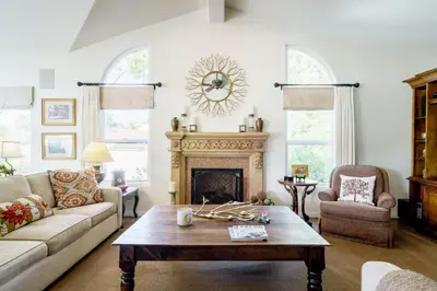 a living room with a couch and a fireplace at Luxury Home with Heated Pool - Spa and Lighted Pickle Ball Court in San Diego