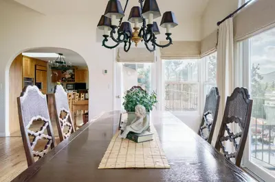 a dining room with a table with a statue sitting on a box at Luxury Home with Heated Pool - Spa and Lighted Pickle Ball Court in San Diego