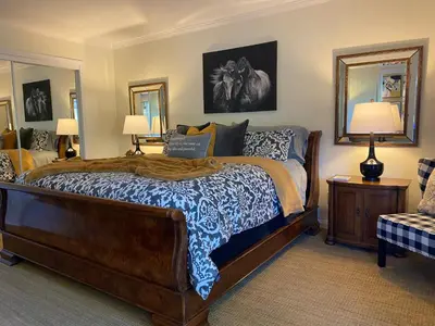 a bedroom with a large bed and two lamps at Luxury Home with Heated Pool - Spa and Lighted Pickle Ball Court in San Diego
