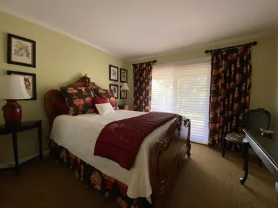 a bedroom with a bed and a window at Luxury Home with Heated Pool - Spa and Lighted Pickle Ball Court in San Diego