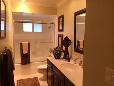 a bathroom with a sink and a toilet and a shower at Luxury Home with Heated Pool - Spa and Lighted Pickle Ball Court in San Diego
