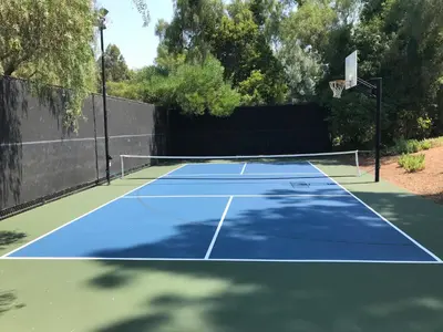 a tennis court with a basketball hoop on it at Luxury Home with Heated Pool - Spa and Lighted Pickle Ball Court in San Diego