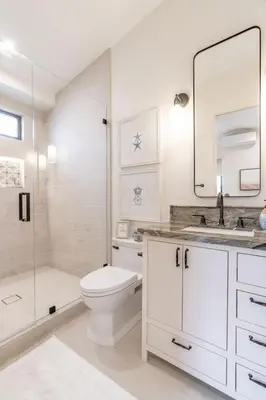 a white bathroom with a toilet and a shower at Enchanting Encinitas Oceanview Casita in Encinitas