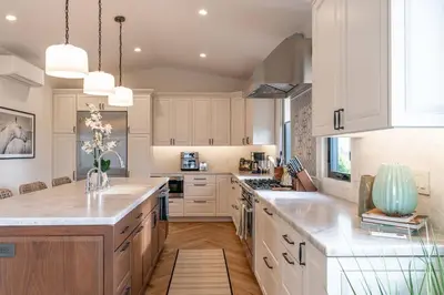 a kitchen with white cabinets and white counter tops at Enchanting Encinitas Oceanview Casita in Encinitas