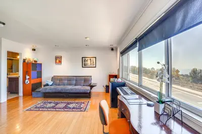 a living room with a couch and a large window at Belle View Laguna Beach Getaway with Patio in Laguna Beach