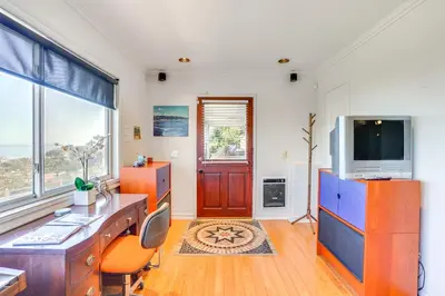 a living room with a desk and a tv and a door at Belle View Laguna Beach Getaway with Patio in Laguna Beach