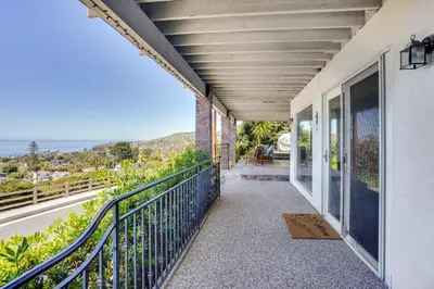 a balcony of a house with a view of the ocean at Belle View Laguna Beach Getaway with Patio in Laguna Beach