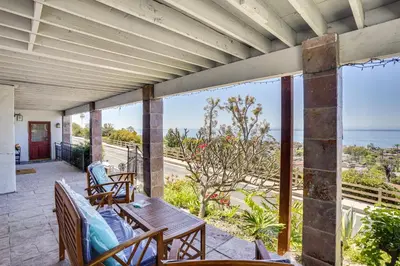 a porch with a table and chairs and the ocean at Belle View Laguna Beach Getaway with Patio in Laguna Beach