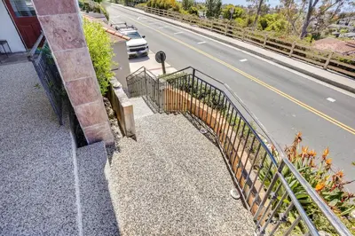 a balcony with a fence and a road at Belle View Laguna Beach Getaway with Patio in Laguna Beach