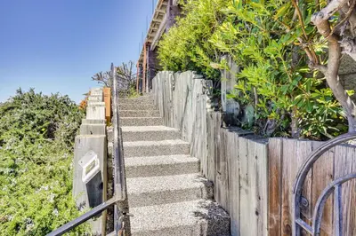 a set of concrete stairs next to a wooden fence at Belle View Laguna Beach Getaway with Patio in Laguna Beach