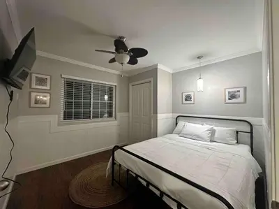 a bedroom with a bed and a ceiling fan at HC Accessible 4 Bed 3 Bath with Sparkling Pool and Spa-we have lifts and roll in shower in Santee