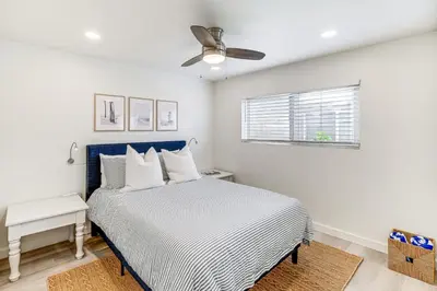 a bedroom with a bed and a ceiling fan at Cardiff Retreat with Game Room and Deck, Near Beach in Cardiff-by-the-Sea