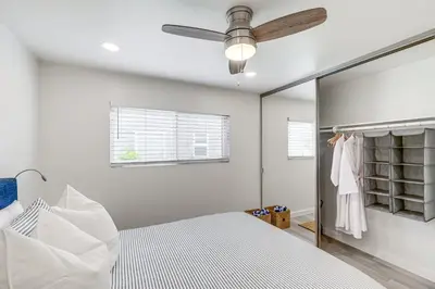a bedroom with a bed and a ceiling fan at Cardiff Retreat with Game Room and Deck, Near Beach in Cardiff-by-the-Sea