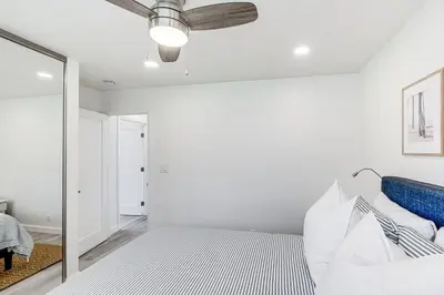 a bedroom with a bed and a mirror at Cardiff Retreat with Game Room and Deck, Near Beach in Cardiff-by-the-Sea