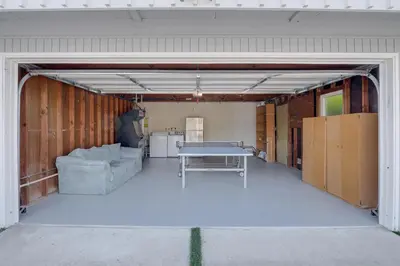 a garage with a couch and a table in it at Cardiff Retreat with Game Room and Deck, Near Beach in Cardiff-by-the-Sea