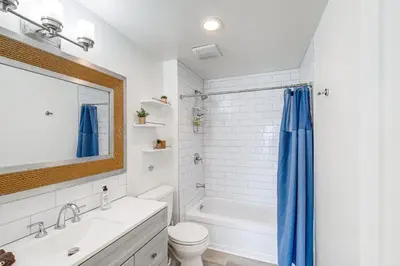 a bathroom with a tub and a toilet and a sink at Cardiff Retreat with Game Room and Deck, Near Beach in Cardiff-by-the-Sea