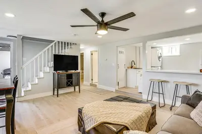 a living room with a couch and a flat screen tv at San Diego Apartment with Patio - Near Balboa Park! in San Diego