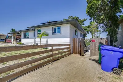a house with a fence and a trash can at San Diego Apartment with Patio - Near Balboa Park! in San Diego
