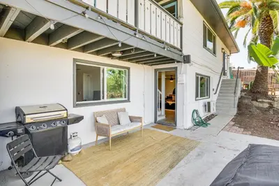 a patio with a grill and a chair and a house at San Diego Apartment with Patio - Near Balboa Park! in San Diego