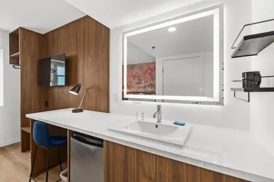 a white kitchen with a sink and a window at Uptown Inn - Limited Service Apart-Hotel in San Diego