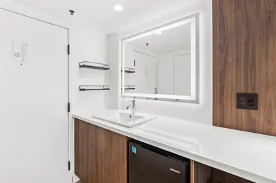 a bathroom with a sink and a mirror at Uptown Inn - Limited Service Apart-Hotel in San Diego