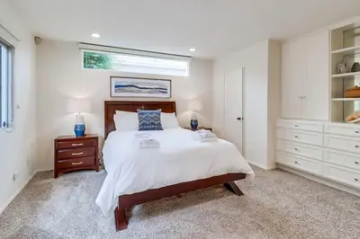 a white bedroom with a bed and a window at Ocean & Bay Views Pool & Hot Tub Rooftop Patio in San Diego