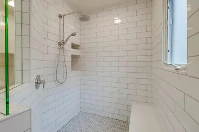 a white tiled bathroom with a shower and a tub at Ocean & Bay Views Pool & Hot Tub Rooftop Patio in San Diego