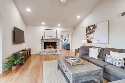 a living room with a couch and a fireplace at Ocean & Bay Views Pool & Hot Tub Rooftop Patio in San Diego