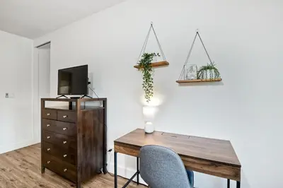 a room with a desk and a tv and a chair at Beautifully Remodeled - Private Balcony - Pool View - BBQ Access - Gated Reserved Parking in Encinitas