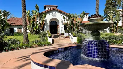 a water fountain in front of a house at Beautifully Remodeled - Private Balcony - Pool View - BBQ Access - Gated Reserved Parking in Encinitas