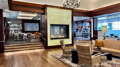 a living room with a couch and a dining room at Beautifully Remodeled - Private Balcony - Pool View - BBQ Access - Gated Reserved Parking in Encinitas