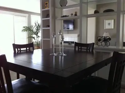 a dining room with a wooden table and chairs at Laguna Condo w/ Pool/Jacuzzi and Attached Garage in Laguna Niguel