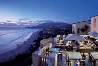 a restaurant with tables and chairs on the beach at Laguna Condo w/ Pool/Jacuzzi and Attached Garage in Laguna Niguel