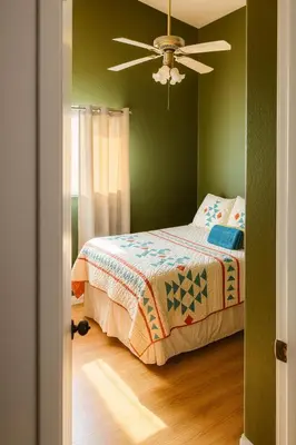 a green bedroom with a bed and a ceiling fan at Peach Blossom Country House in Hemet