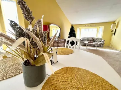 a living room with a potted plant on a table at Peach Blossom Country House in Hemet