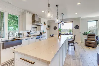 a kitchen with white cabinets and a wooden counter top at LA COSTA Valley Newly Remodeled Gem in Carlsbad