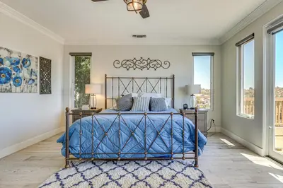 a bedroom with a bed with a blue bedspread at LA COSTA Valley Newly Remodeled Gem in Carlsbad